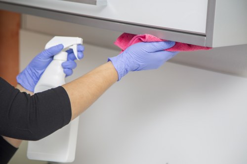 Trained carpet cleaner using protective gloves and mask